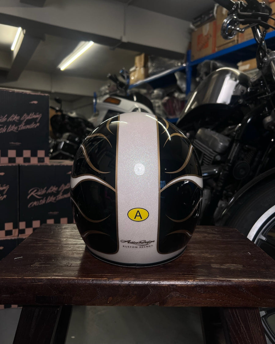 Motorcycle helmet with a visible brand logo on a wooden surface in a garage setting.