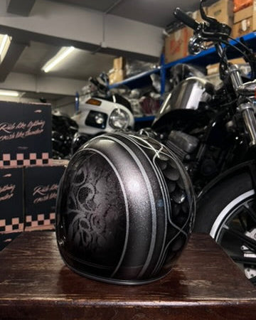 Close-up of a motorcycle engine with a blurred background of a garage.