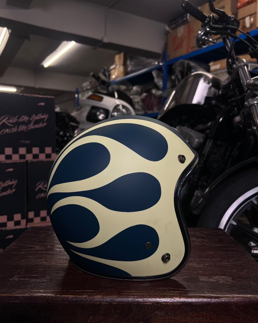 Helmet with a blue and beige pattern on a wooden surface in a garage setting