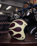 Motorcycle helmet with flame design on a wooden surface in a warehouse setting