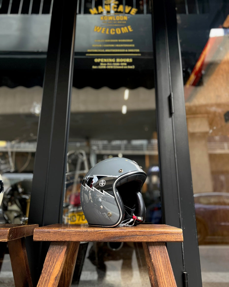 Helmet on a wooden stool in front of a store entrance with 'The Man Cave' sign.