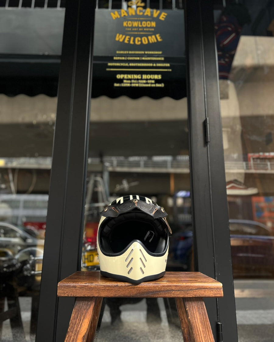 Motorcycle helmet on a wooden block with a sign in the background
