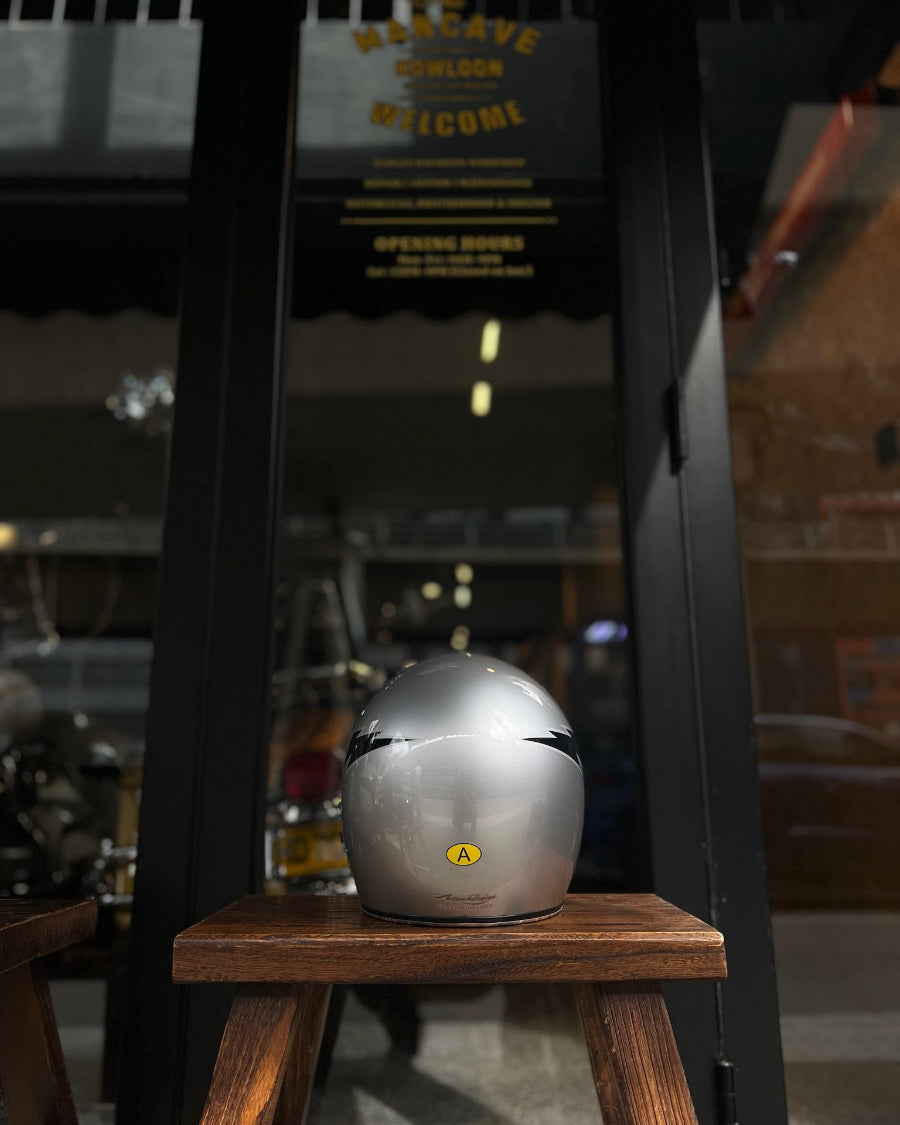Silver helmet on a wooden stand with a blurred background