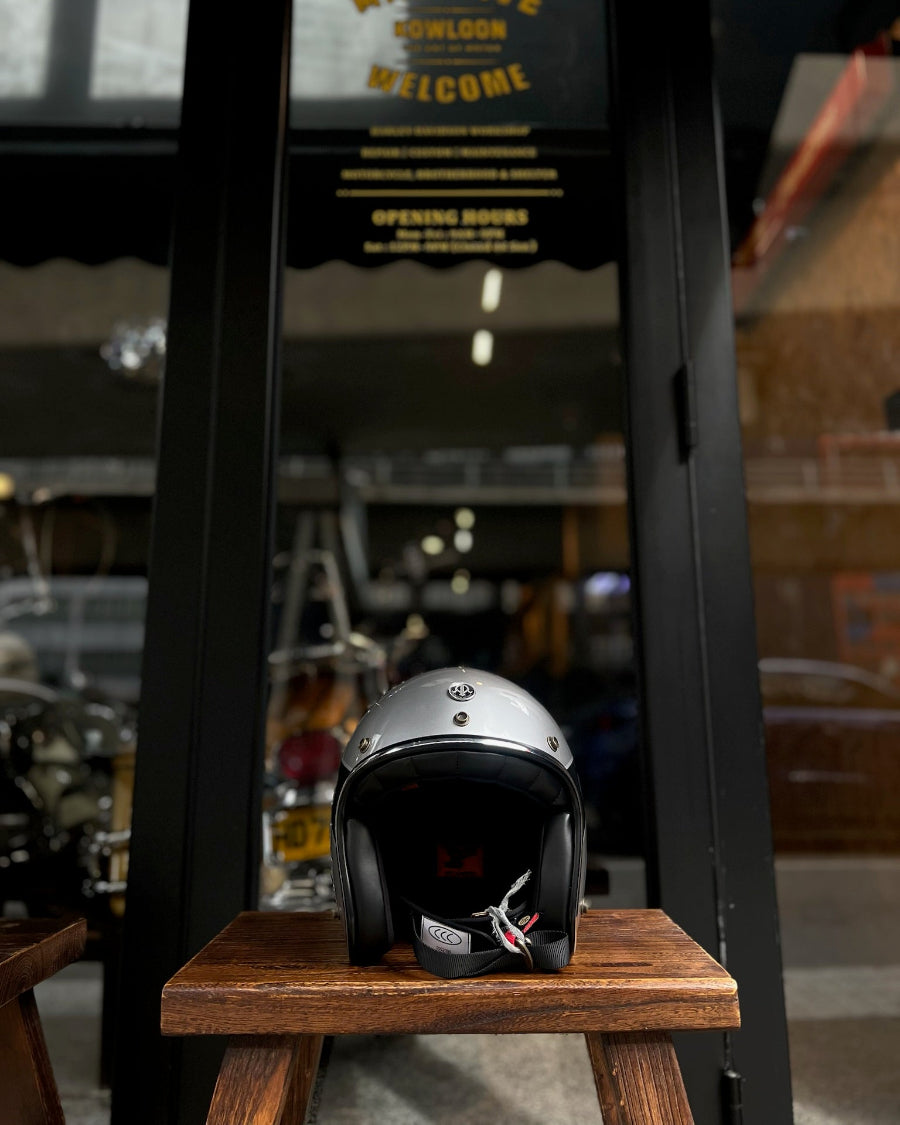 Helmet on a wooden stand with a blurred background of a store entrance.