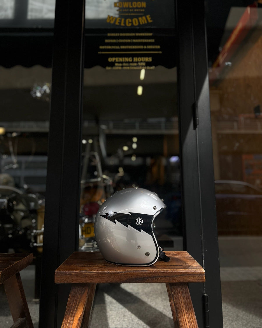 Silver helmet on a wooden stool with a blurred background of a bar or pub.