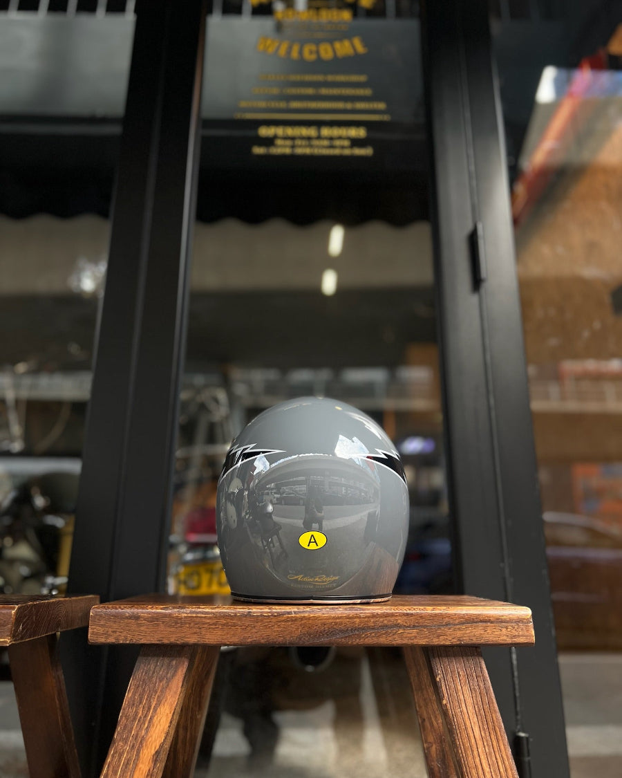 Gray helmet on a wooden stand with a blurred background
