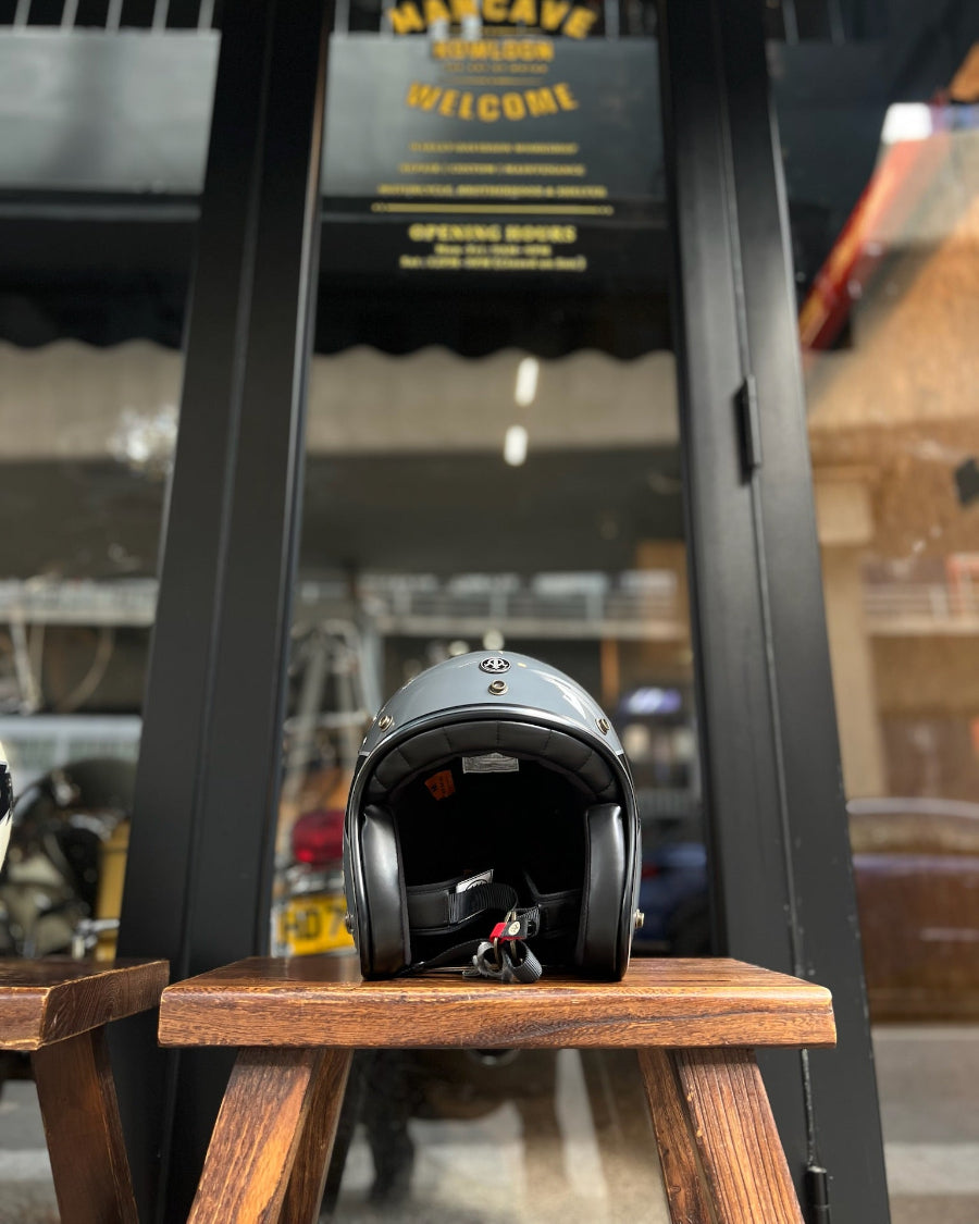 Helmet on a wooden stool with 'The Cave' sign in the background