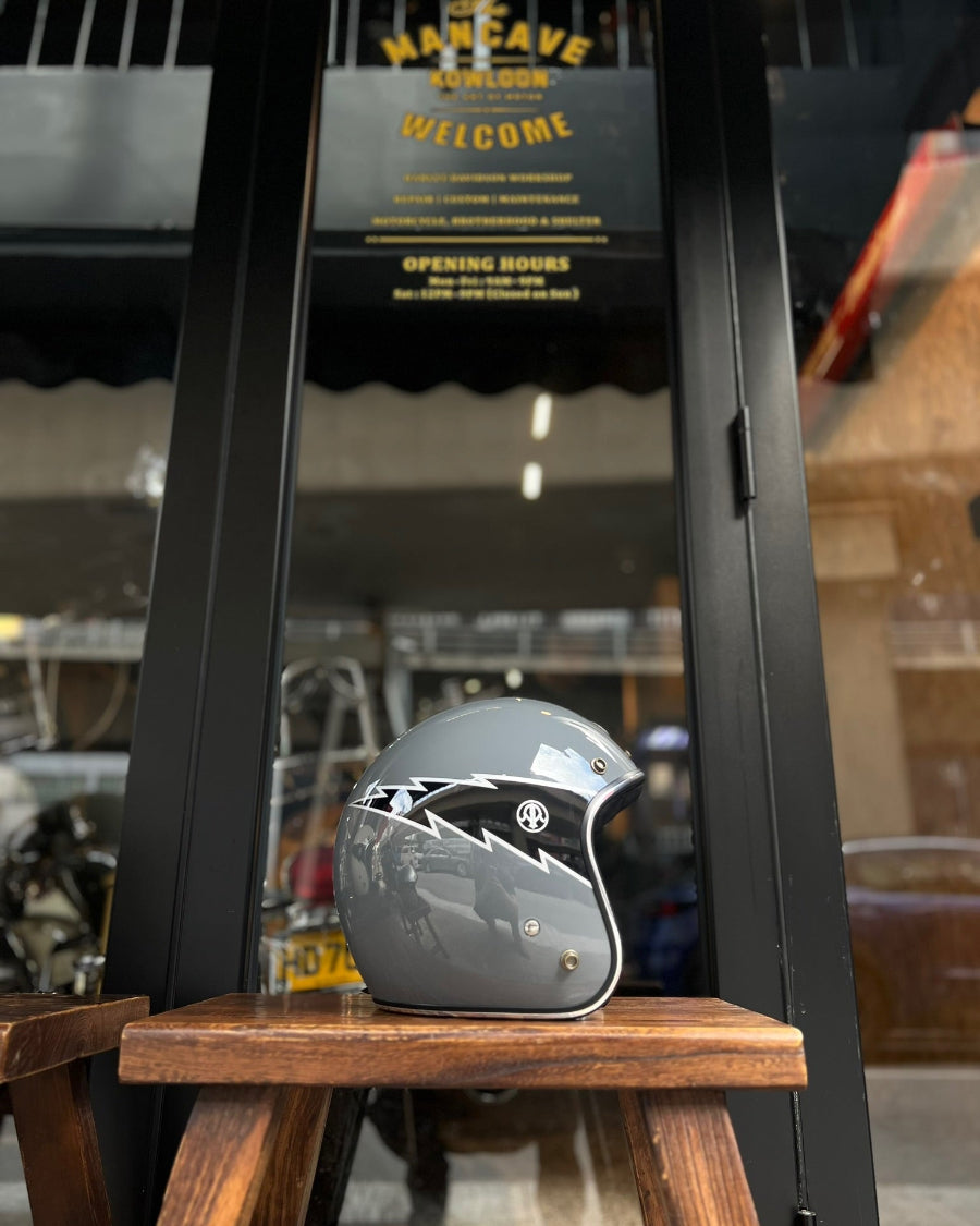 Gray motorcycle helmet on a wooden stool with a blurred background