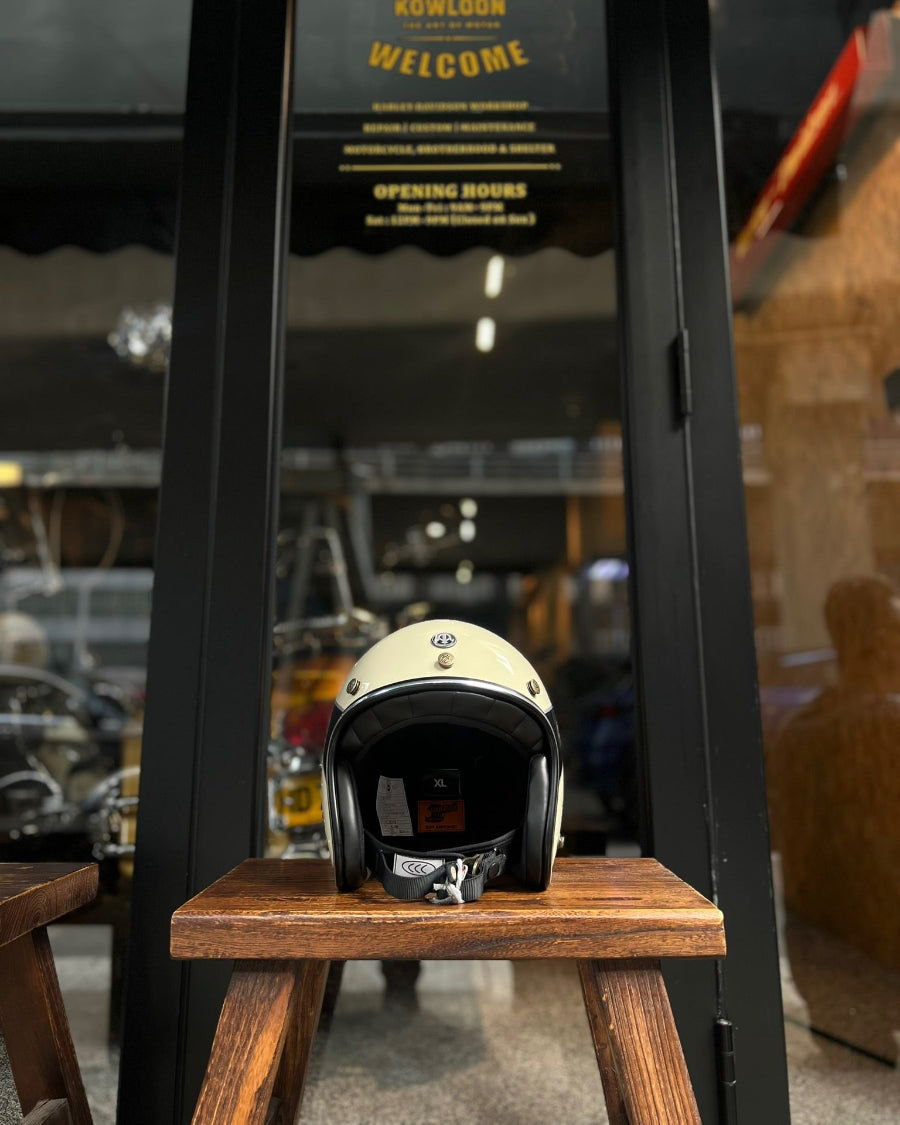 Helmet on a wooden stool with a store entrance in the background