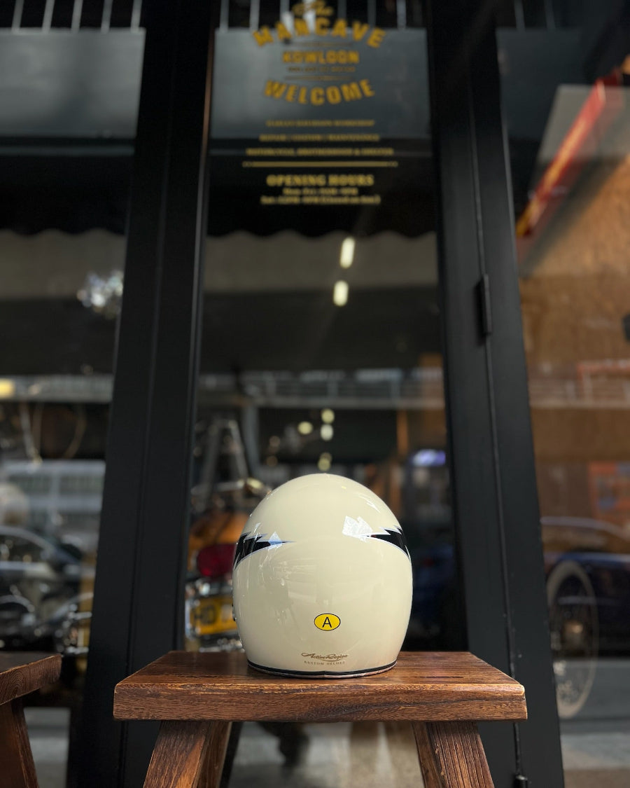 White helmet on a wooden stool with a blurred background of a store entrance.