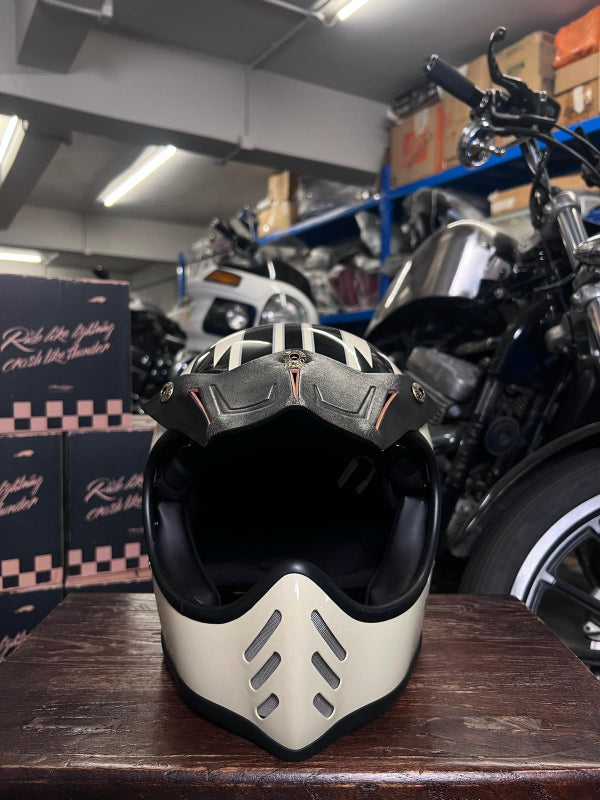 White Air Runner motorcycle helmet and Urban soul visor on a wooden surface with a motorcycle and boxes in The Mancave Kowloon shop.